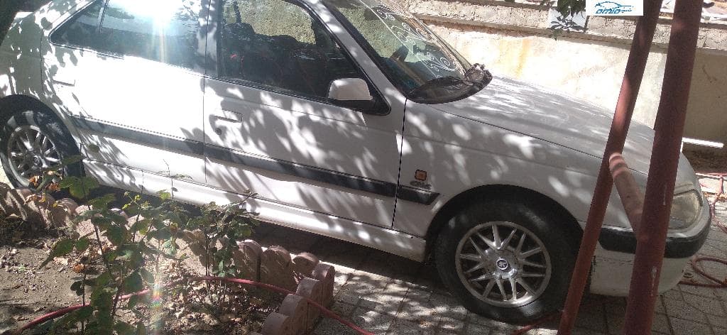 پژو پارس دوگانه کارخانه مدل ۹۱ رنگ سفید دوره درنگ از سمت راننده ضربه دار - Image 1